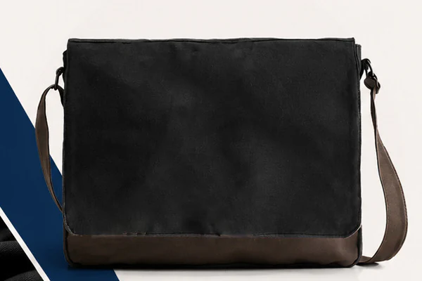 Black canvas messenger bag with leather-look base panel and adjustable strap