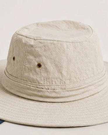 Cream cotton bucket hat with metal eyelets